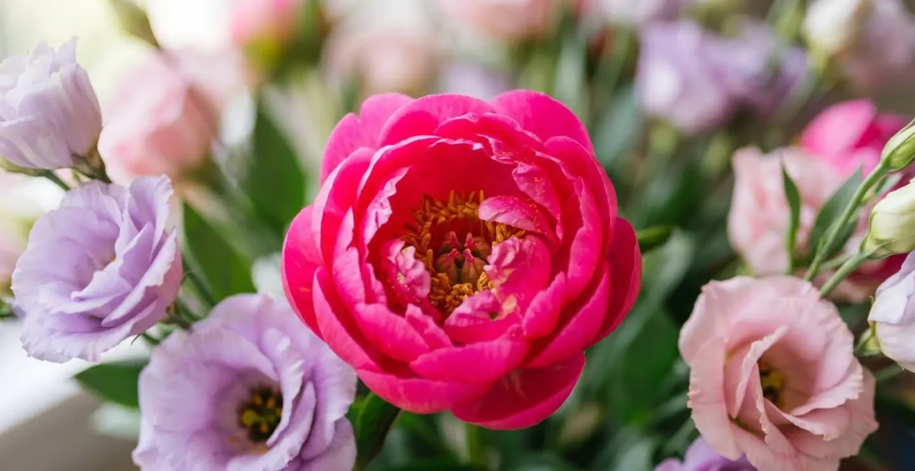Macro close-up showing visual weight principle with high-saturation neon flower at arrangement center versus low-saturation pastels at periphery